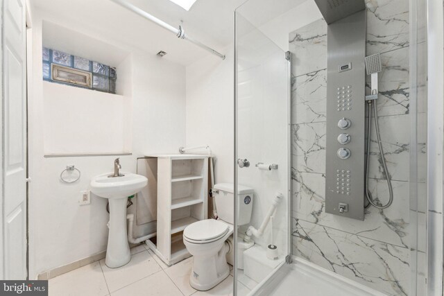 251 S 46th St, Philadelphia, PA 19139 - bathroom featuring toilet, a marble finish shower, tile patterned flooring, and a sink