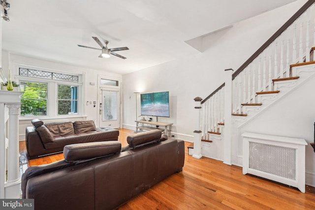 251 S 46th St, Philadelphia, PA 19139 - living area featuring stairway, a ceiling fan, radiator heating unit, and wood finished floors