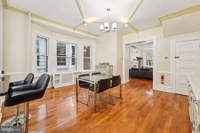 251 S 46th St, Philadelphia, PA 19139 - dining room with light wood finished floors, crown molding, and a notable chandelier