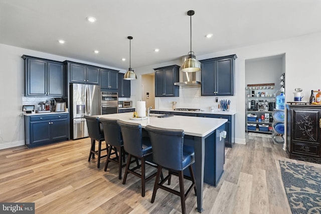 131 Boxelder Dr, Stafford, VA 22554 - kitchen featuring tasteful backsplash, a breakfast bar area, stainless steel appliances, light wood-style floors, and light countertops