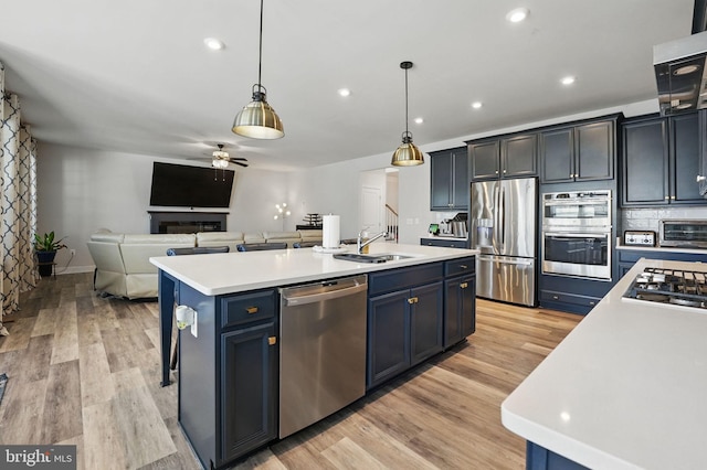 131 Boxelder Dr, Stafford, VA 22554 - kitchen with open floor plan, appliances with stainless steel finishes, light countertops, and a sink