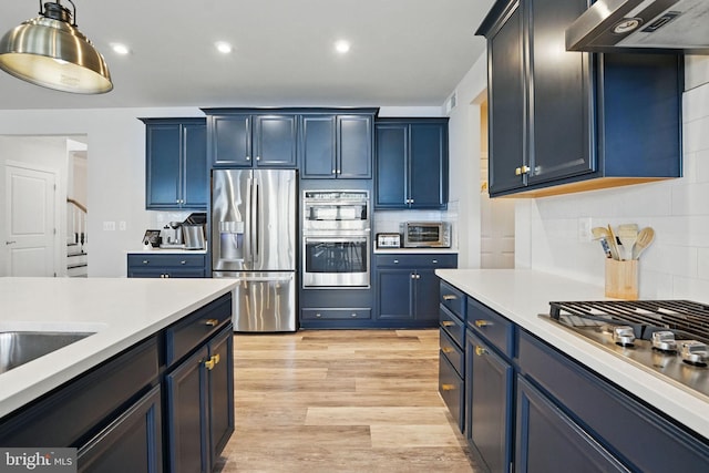 131 Boxelder Dr, Stafford, VA 22554 - kitchen with appliances with stainless steel finishes, light countertops, blue cabinets, and under cabinet range hood