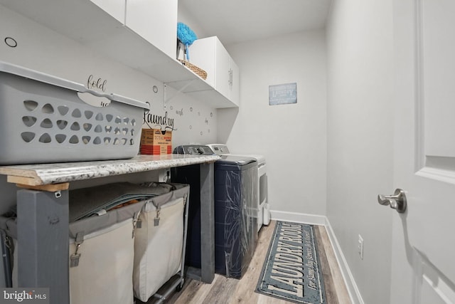 131 Boxelder Dr, Stafford, VA 22554 - laundry room featuring washer and dryer, cabinet space, light wood-style flooring, and baseboards