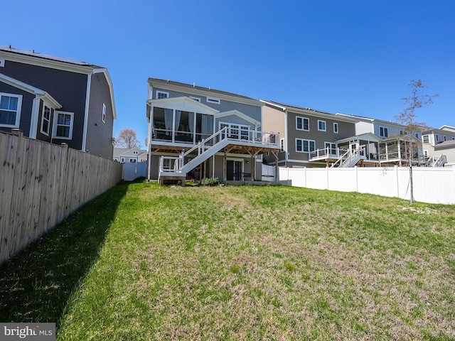 131 Boxelder Dr, Stafford, VA 22554 - rear view of house featuring a fenced backyard, stairs, a wooden deck, a sunroom, and a lawn