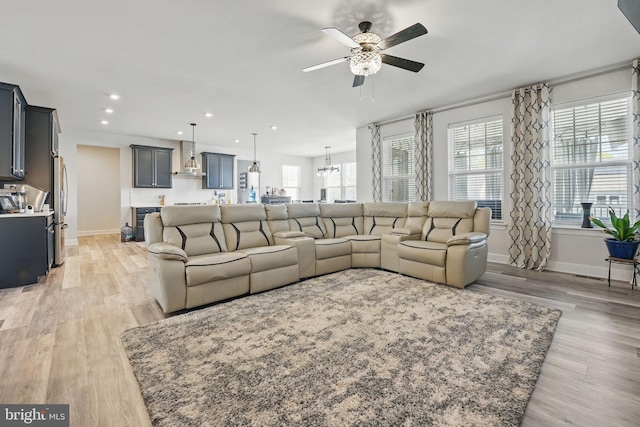 131 Boxelder Dr, Stafford, VA 22554 - living area with baseboards, light wood-type flooring, and ceiling fan with notable chandelier