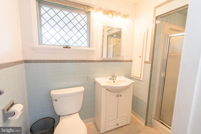 full bathroom with vanity, tile walls, a stall shower, and toilet