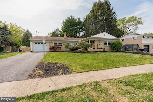 single story home featuring a garage, a front lawn, driveway, and a chimney