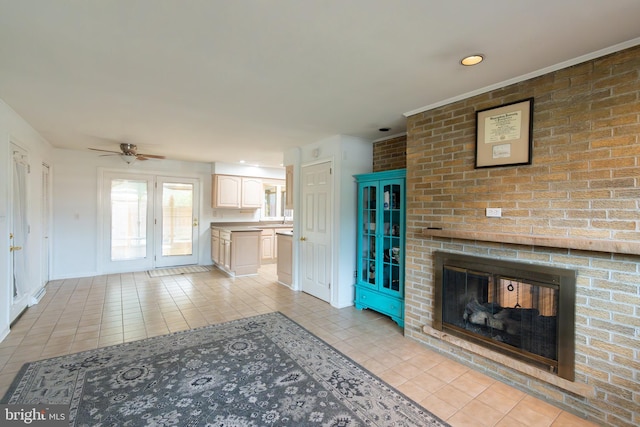 unfurnished living room featuring a ceiling fan, light tile patterned flooring, and a brick fireplace