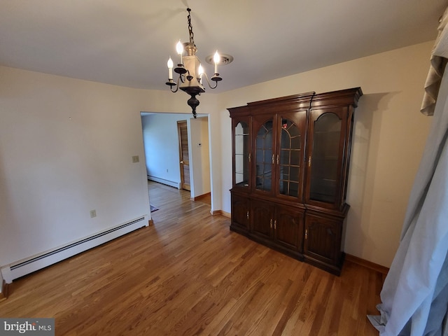 212 University Dr, Mont Alto, PA 17237 - unfurnished dining area featuring baseboards, light wood-type flooring, a chandelier, and baseboard heating