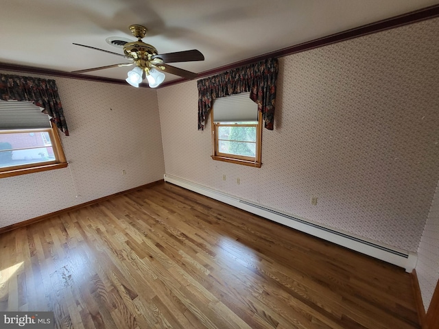 212 University Dr, Mont Alto, PA 17237 - unfurnished room featuring crown molding, a baseboard heating unit, wallpapered walls, ceiling fan, and wood finished floors