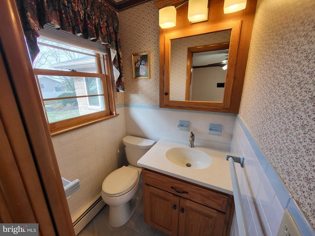 212 University Dr, Mont Alto, PA 17237 - half bathroom featuring tile walls, toilet, baseboard heating, wallpapered walls, and wainscoting