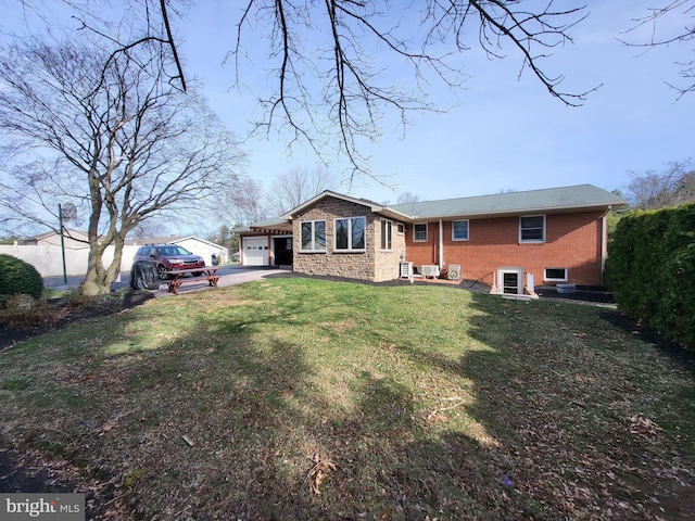 212 University Dr, Mont Alto, PA 17237 - view of front facade featuring a front lawn, brick siding, aphalt driveway, and an attached garage