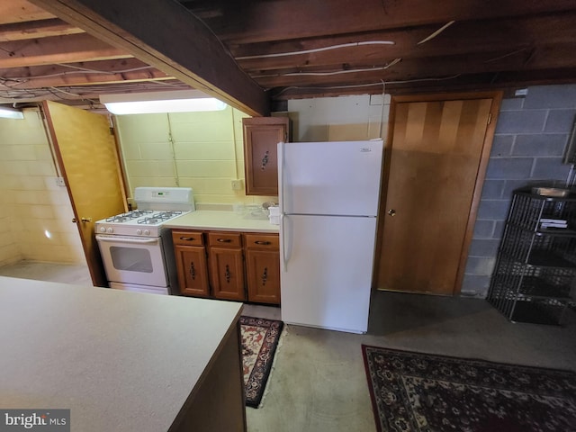 212 University Dr, Mont Alto, PA 17237 - kitchen with light countertops, concrete flooring, brown cabinets, and white appliances