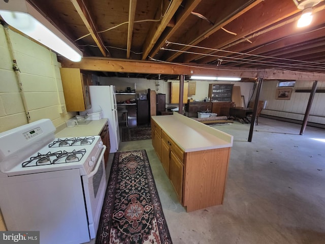212 University Dr, Mont Alto, PA 17237 - kitchen with light countertops, concrete flooring, white appliances, a center island, and brown cabinets