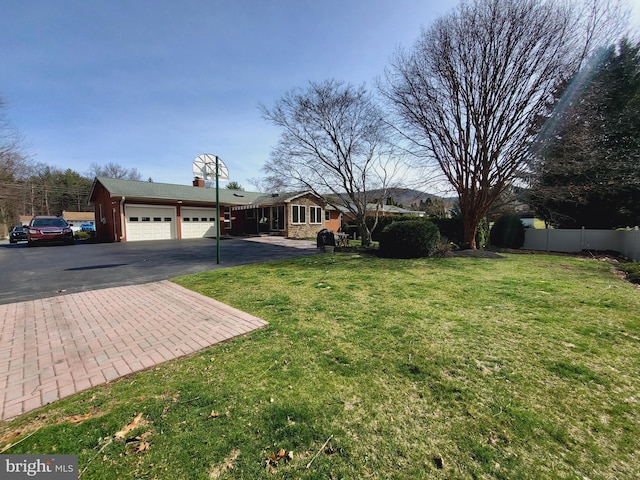212 University Dr, Mont Alto, PA 17237 - view of yard featuring fence, driveway, and a garage