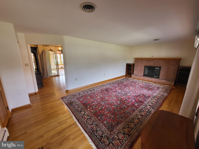 212 University Dr, Mont Alto, PA 17237 - living room with baseboards, visible vents, light wood-style floors, and a brick fireplace