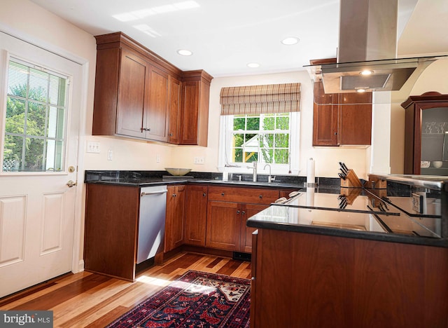 kitchen featuring island range hood, light wood-type flooring, dishwasher, brown cabinets, and recessed lighting