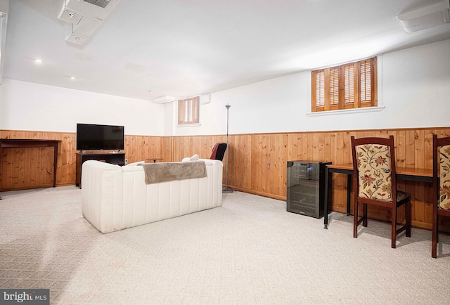 living room with wainscoting and wooden walls