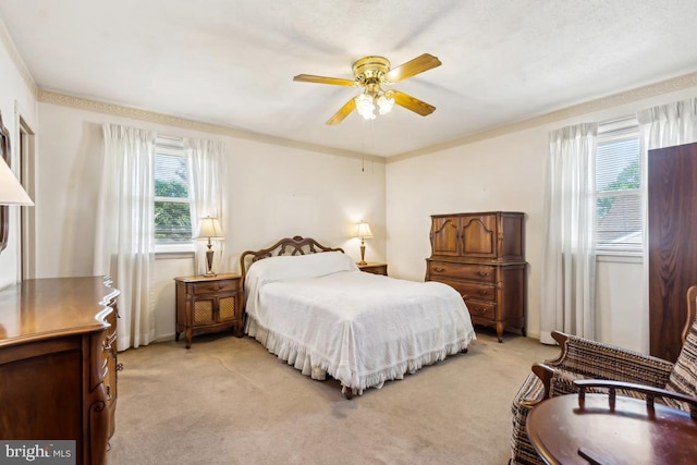 bedroom featuring a ceiling fan and light colored carpet