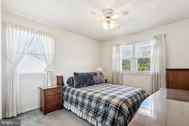 bedroom featuring baseboards, a ceiling fan, and light carpet