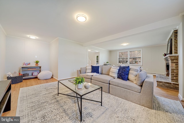 living room featuring crown molding, a brick fireplace, baseboards, wood finished floors, and baseboard heating