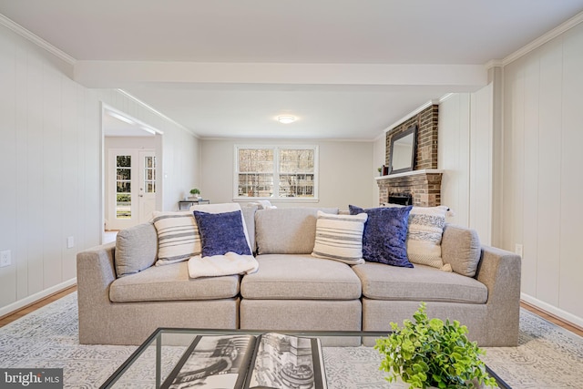 living area with plenty of natural light, wood finished floors, and ornamental molding
