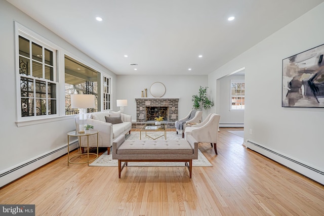 living room featuring a fireplace, wood finished floors, recessed lighting, and baseboard heating