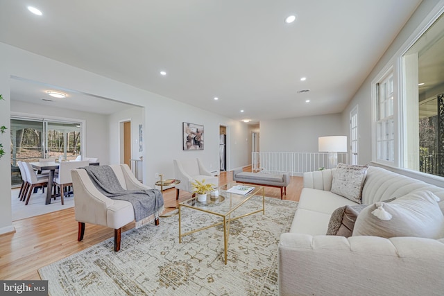 living area with light wood-style flooring and recessed lighting
