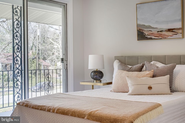 bedroom featuring multiple windows and access to outside