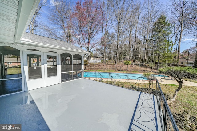 view of pool featuring french doors, a fenced in pool, a sunroom, and a patio area