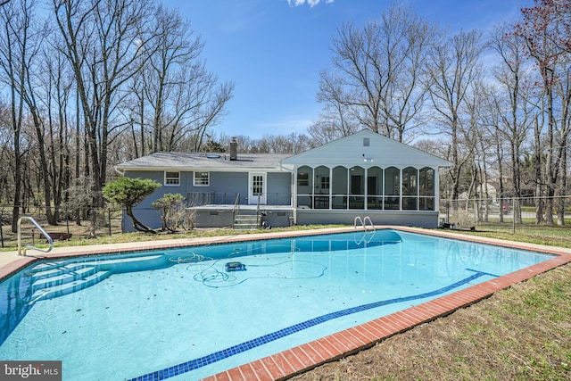 view of pool featuring a sunroom, fence, and a fenced in pool