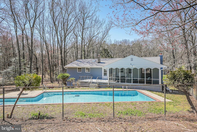 view of pool with a sunroom, fence, and a fenced in pool