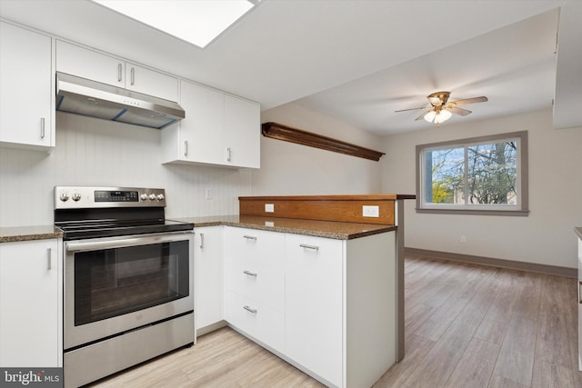 kitchen with a peninsula, light wood-style flooring, white cabinetry, stainless steel range with electric stovetop, and under cabinet range hood