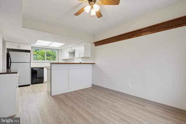kitchen with white cabinets, under cabinet range hood, dishwasher, freestanding refrigerator, and a peninsula