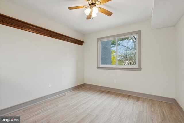 unfurnished room with light wood-style floors, baseboards, and ceiling fan