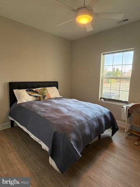 30609 Cedar Neck Rd Unit 3109, Ocean View, DE 19970 - bedroom featuring baseboards, visible vents, wood finished floors, and ceiling fan