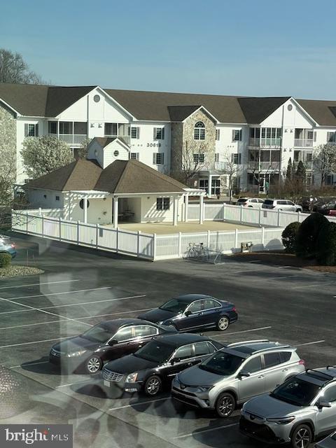 30609 Cedar Neck Rd Unit 3109, Ocean View, DE 19970 - uncovered parking lot featuring a residential view and fence