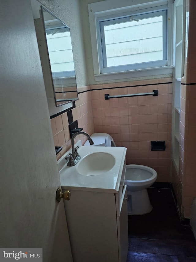 246 S Logan Ave, Trenton, NJ 08629 - bathroom featuring plenty of natural light, tile walls, vanity, and a wainscoted wall