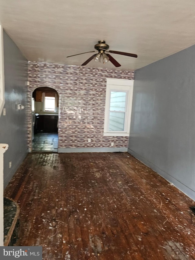 246 S Logan Ave, Trenton, NJ 08629 - unfurnished living room featuring ceiling fan, hardwood / wood-style flooring, and arched walkways