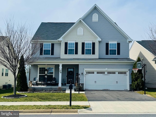 162 Blackford Dr, Stephenson, VA 22656 - traditional-style home with an attached garage, central AC unit, aphalt driveway, a front yard, and a porch