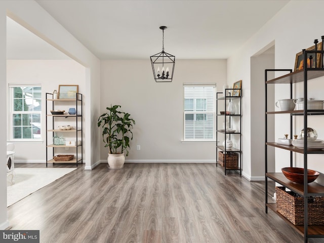 162 Blackford Dr, Stephenson, VA 22656 - dining area featuring baseboards, wood finished floors, and a notable chandelier