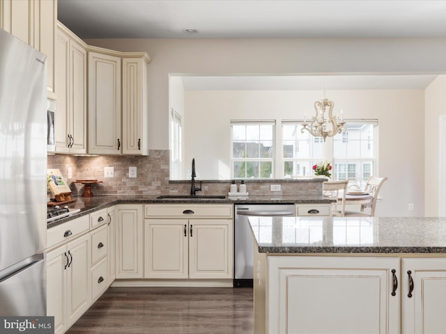 162 Blackford Dr, Stephenson, VA 22656 - kitchen featuring a chandelier, dark wood finished floors, backsplash, a sink, and appliances with stainless steel finishes