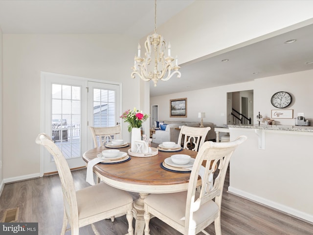 162 Blackford Dr, Stephenson, VA 22656 - dining area featuring baseboards, lofted ceiling, wood finished floors, and an inviting chandelier