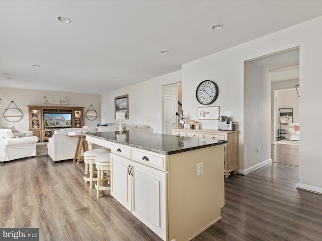 162 Blackford Dr, Stephenson, VA 22656 - kitchen with a center island, open floor plan, dark wood finished floors, and dark stone counters