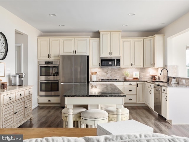 162 Blackford Dr, Stephenson, VA 22656 - kitchen featuring cream cabinets, a sink, stainless steel appliances, and dark stone countertops