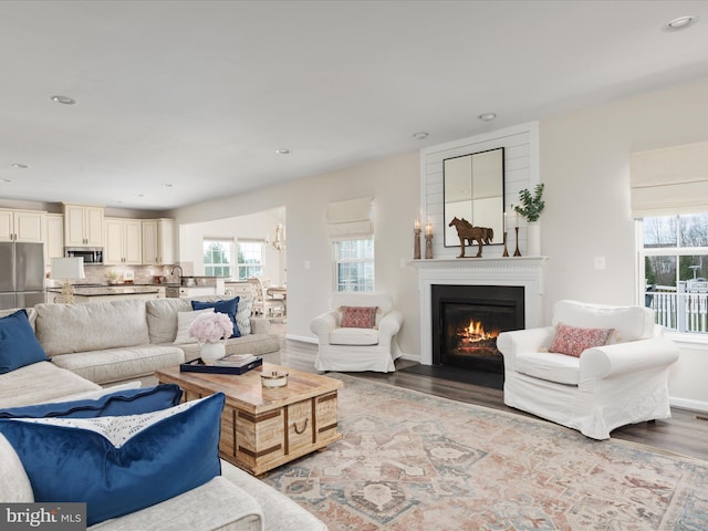 162 Blackford Dr, Stephenson, VA 22656 - living room featuring wood finished floors, recessed lighting, a fireplace with flush hearth, and a wealth of natural light