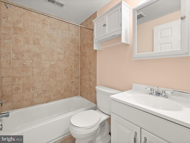 bathroom featuring toilet, vanity, bathing tub / shower combination, and visible vents