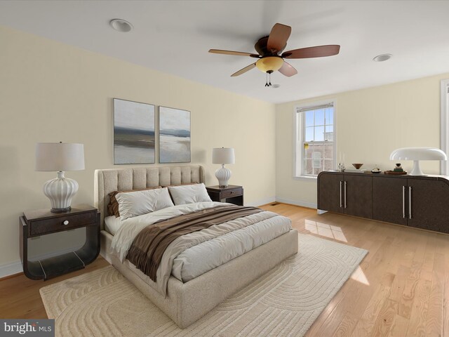 bedroom with light wood-style flooring, baseboards, and ceiling fan