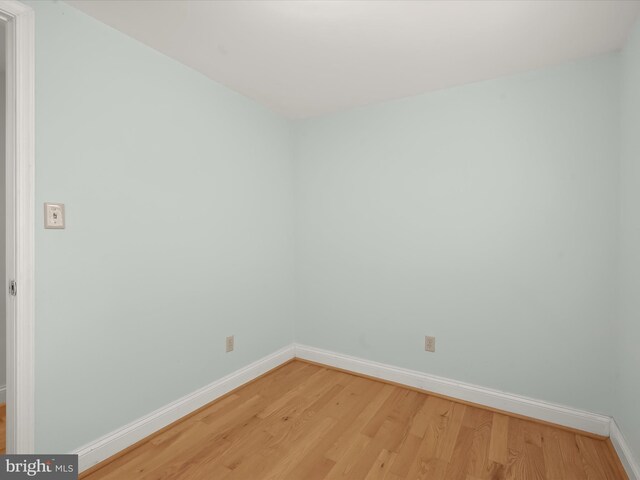 unfurnished room with baseboards and light wood finished floors