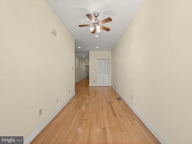 interior space with baseboards, light wood-style flooring, recessed lighting, and a ceiling fan